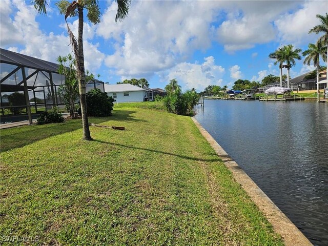 3616 SW 1st Pl, Cape Coral, FL 33914 - view of grassy yard with a water view and glass enclosure