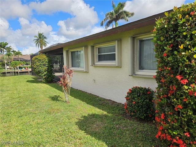 3616 SW 1st Pl, Cape Coral, FL 33914 - view of property exterior featuring stucco siding and a lawn