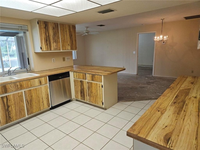 3616 SW 1st Pl, Cape Coral, FL 33914 - kitchen with dishwasher, a peninsula, a chandelier, light tile patterned floors, and brown cabinets