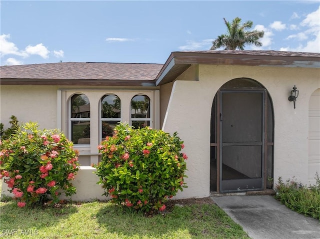 3616 SW 1st Pl, Cape Coral, FL 33914 - entrance to property with stucco siding and roof with shingles