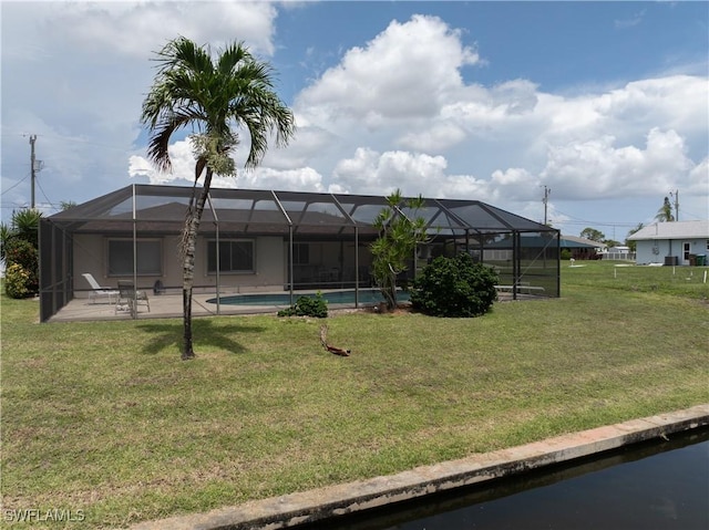 3616 SW 1st Pl, Cape Coral, FL 33914 - rear view of property featuring a yard, a patio, an outdoor pool, and glass enclosure