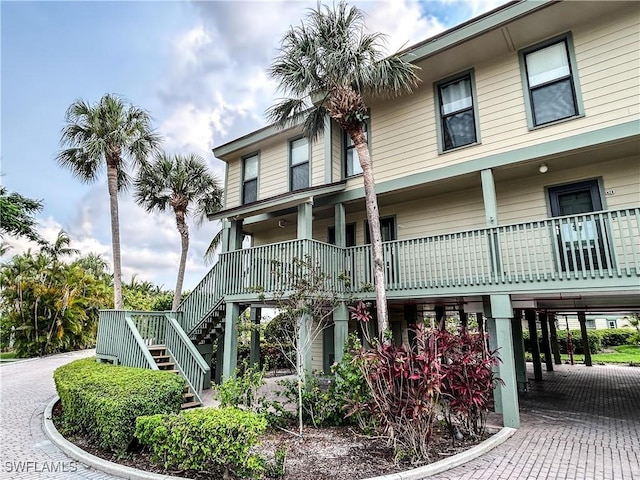 16750 Bocilla Palms Dr Unit 74, Bokeelia, FL 33922 - view of building exterior featuring stairway, a carport, and driveway