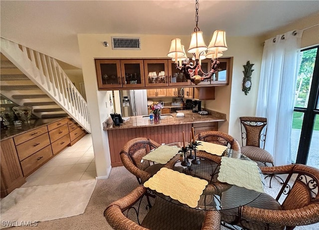 16750 Bocilla Palms Dr Unit 74, Bokeelia, FL 33922 - dining area featuring stairway, light colored carpet, and a chandelier