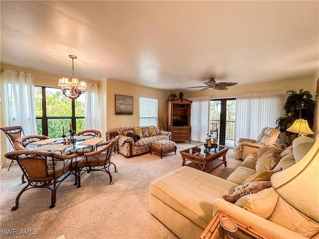 16750 Bocilla Palms Dr Unit 74, Bokeelia, FL 33922 - living room featuring light colored carpet, a chandelier, and ceiling fan