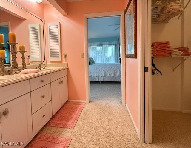 16750 Bocilla Palms Dr Unit 74, Bokeelia, FL 33922 - ensuite bathroom with double vanity, carpet floors, and a spacious closet