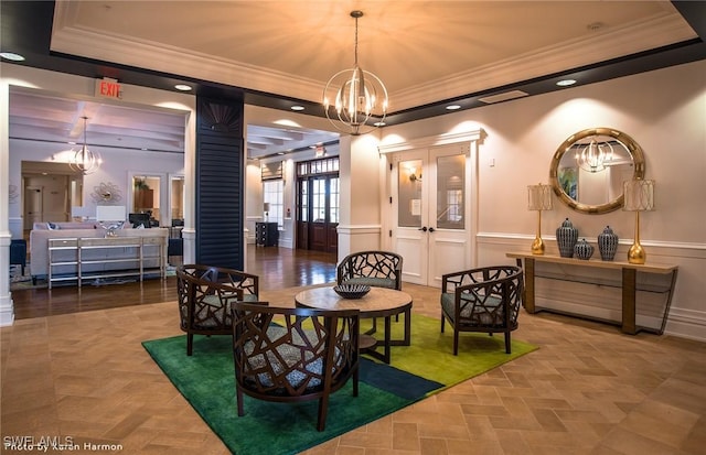 3706 Wild Sage Way, Alva, FL 33920 - dining room with crown molding, a tray ceiling, a chandelier, ornate columns, and wainscoting