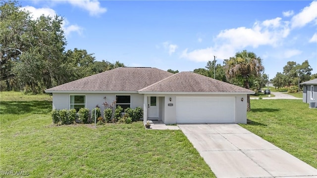 1429 Jabara Cir, Labelle, FL 33935 - single story home featuring stucco siding, an attached garage, driveway, and a front lawn