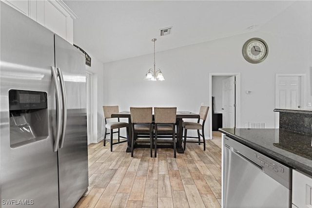 1429 Jabara Cir, Labelle, FL 33935 - dining space with a chandelier, light wood finished floors, and high vaulted ceiling