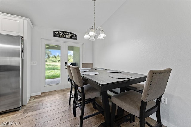 1429 Jabara Cir, Labelle, FL 33935 - dining room with french doors, light wood-style floors, a chandelier, and vaulted ceiling