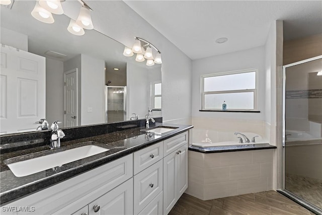 1429 Jabara Cir, Labelle, FL 33935 - bathroom featuring a shower stall, a bath, double vanity, and wood finished floors