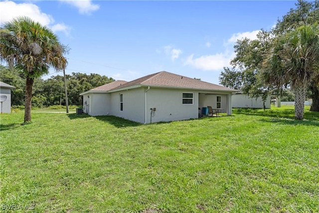 1429 Jabara Cir, Labelle, FL 33935 - back of property with a lawn and stucco siding