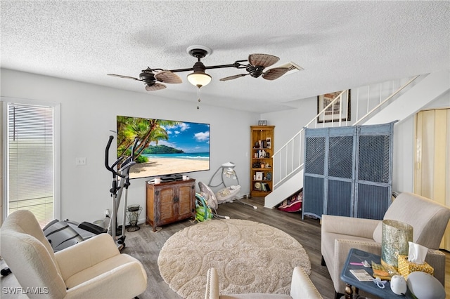 3291 Royal Canadian Trce Unit 3, Fort Myers, FL 33907 - living area with stairway, wood finished floors, ceiling fan, and a textured ceiling