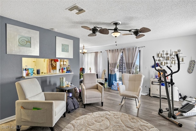 3291 Royal Canadian Trce Unit 3, Fort Myers, FL 33907 - living area featuring ceiling fan, wood finished floors, a chandelier, and a textured ceiling