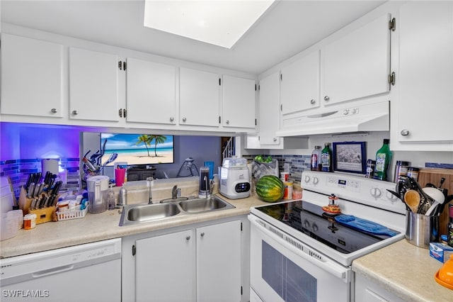 3291 Royal Canadian Trce Unit 3, Fort Myers, FL 33907 - kitchen with white appliances, under cabinet range hood, light countertops, white cabinets, and tasteful backsplash