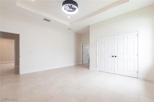 10295 Carolina St, Bonita Springs, FL 34135 - unfurnished bedroom featuring a tray ceiling and a closet