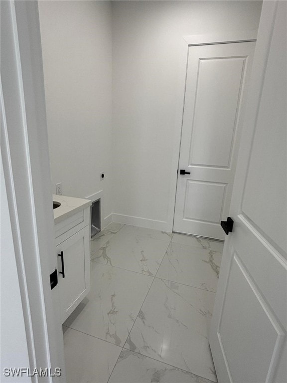 2909 Dora Ave N, Lehigh Acres, FL 33971 - bathroom featuring marble look tile flooring and vanity
