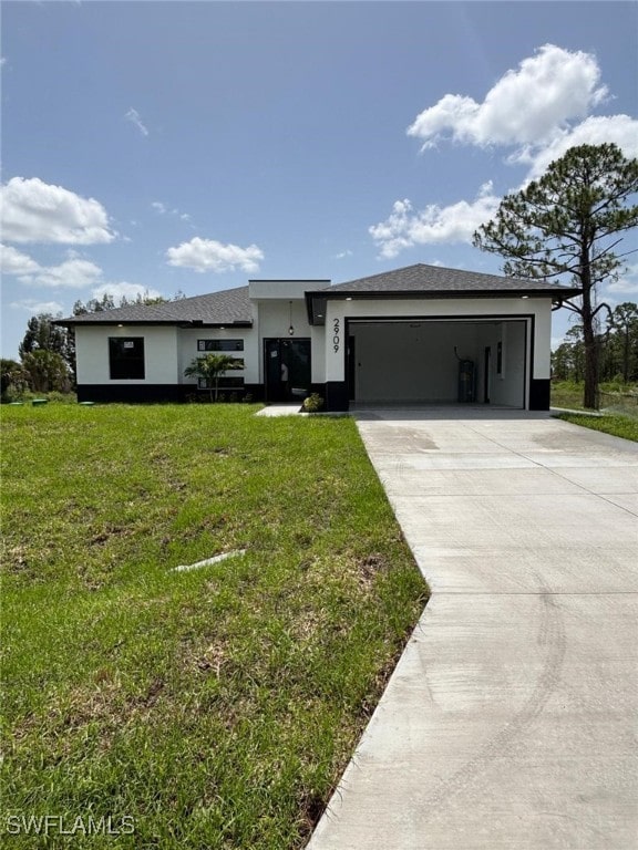 2909 Dora Ave N, Lehigh Acres, FL 33971 - view of front facade with stucco siding, concrete driveway, a front lawn, and a garage