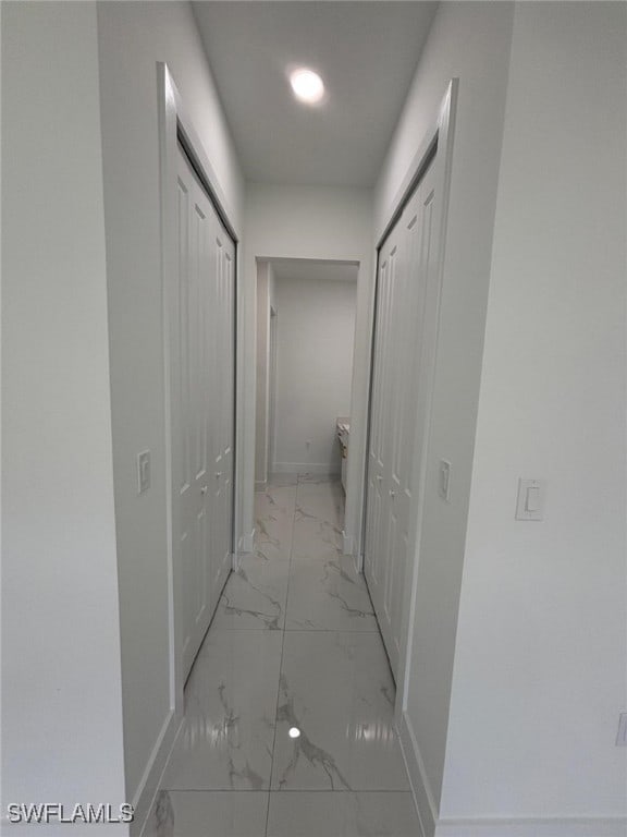 2909 Dora Ave N, Lehigh Acres, FL 33971 - hallway with light marble finish floors and baseboards