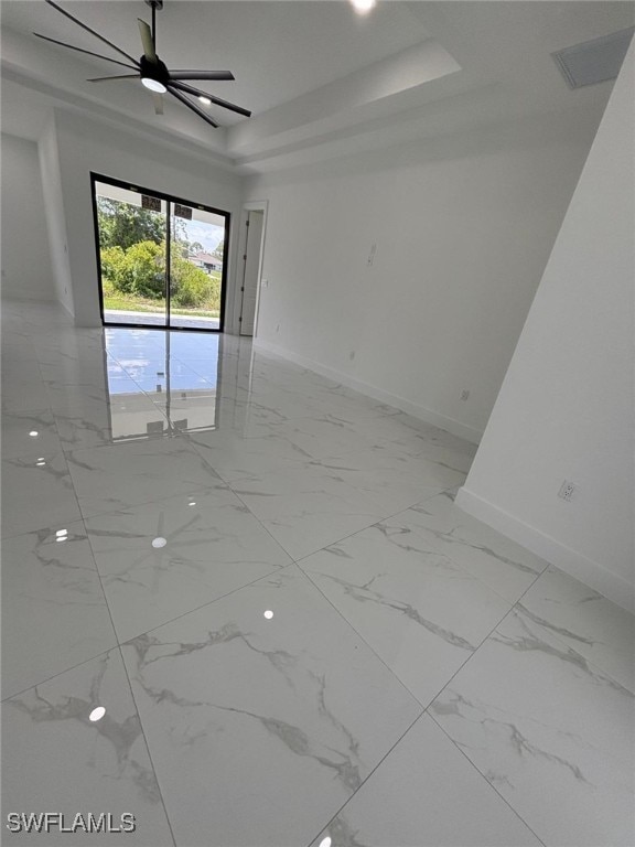 2909 Dora Ave N, Lehigh Acres, FL 33971 - spare room with a raised ceiling and light marble finish floors