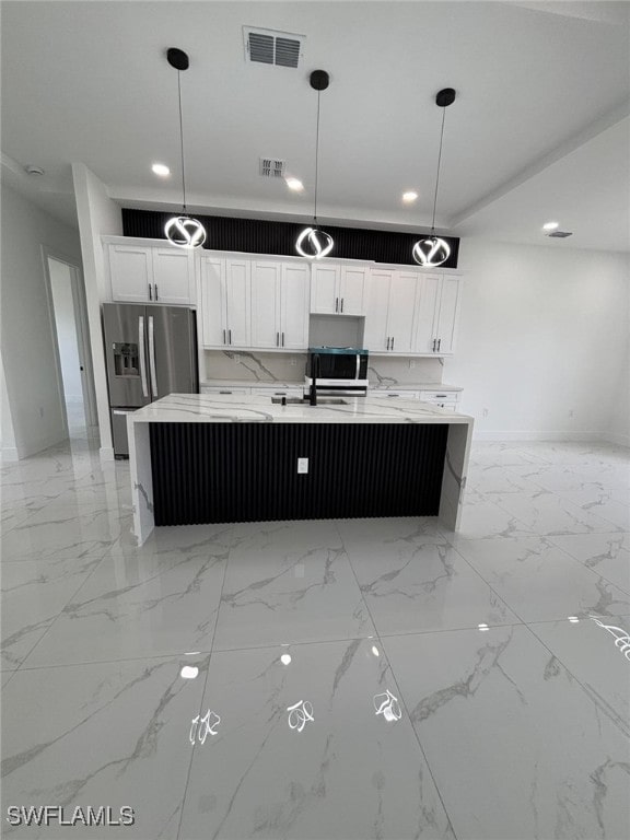 2909 Dora Ave N, Lehigh Acres, FL 33971 - kitchen featuring stainless steel appliances, recessed lighting, white cabinetry, light marble finish floors, and a spacious island
