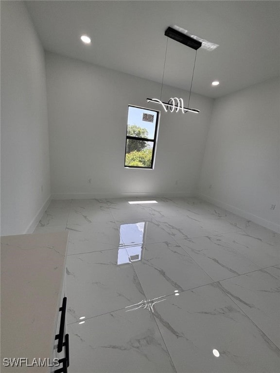 2909 Dora Ave N, Lehigh Acres, FL 33971 - spare room featuring light marble finish floors and recessed lighting