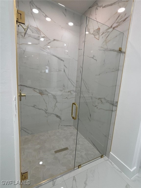 2909 Dora Ave N, Lehigh Acres, FL 33971 - bathroom featuring a marble finish shower and marble look tiles