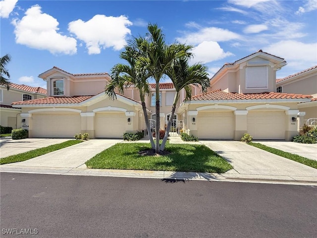 15054 Tamarind Cay Ct Unit 706, Fort Myers, FL 33908 - mediterranean / spanish home featuring stucco siding, a tiled roof, and concrete driveway