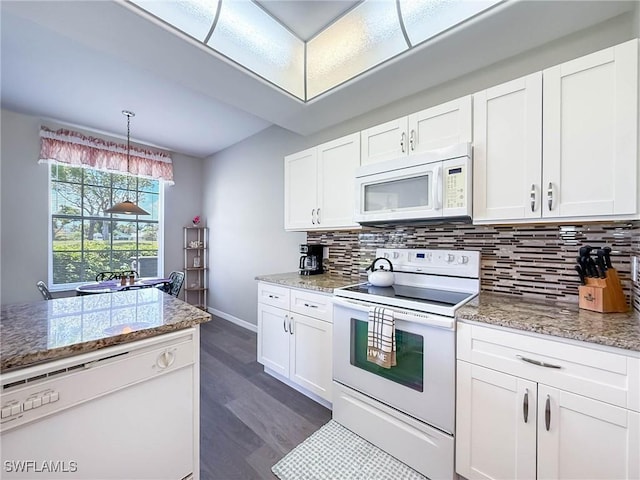 15054 Tamarind Cay Ct Unit 706, Fort Myers, FL 33908 - kitchen with white appliances, tasteful backsplash, and white cabinetry