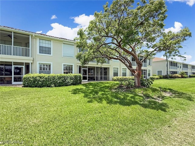 15054 Tamarind Cay Ct Unit 706, Fort Myers, FL 33908 - back of house with a lawn, stucco siding, and a ceiling fan