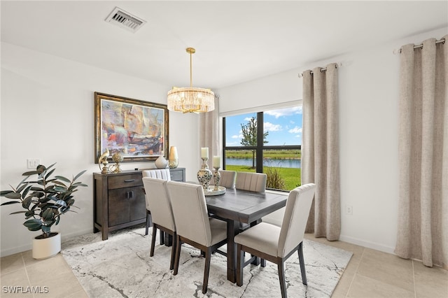6334 Achievement Ave, Ave Maria, FL 34142 - dining area with a chandelier, a water view, light tile patterned floors, and baseboards