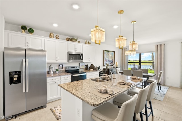 6334 Achievement Ave, Ave Maria, FL 34142 - kitchen featuring appliances with stainless steel finishes, light tile patterned floors, white cabinets, and recessed lighting