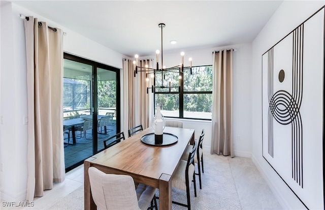 3740 Passion Vine Dr, Alva, FL 33920 - dining area featuring a chandelier, healthy amount of natural light, light tile patterned flooring, and baseboards