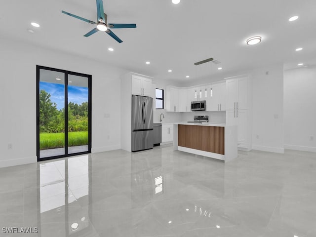 3301 8th St SW, Lehigh Acres, FL 33976 - kitchen featuring stainless steel appliances, baseboards, ceiling fan, light countertops, and recessed lighting