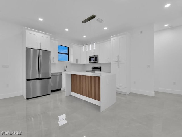 3301 8th St SW, Lehigh Acres, FL 33976 - kitchen featuring stainless steel appliances, white cabinetry, light countertops, a kitchen island, and recessed lighting