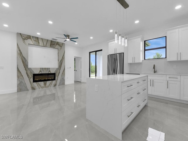 3301 8th St SW, Lehigh Acres, FL 33976 - kitchen with freestanding refrigerator, recessed lighting, light marble finish flooring, ceiling fan, and a kitchen island