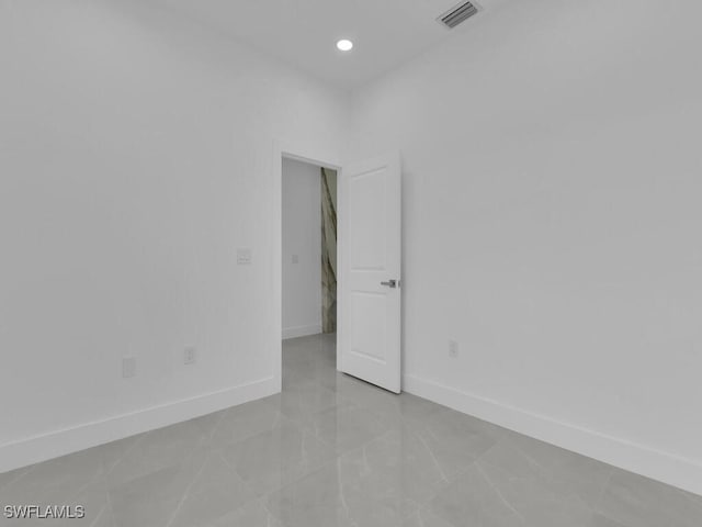 3301 8th St SW, Lehigh Acres, FL 33976 - spare room with baseboards and recessed lighting