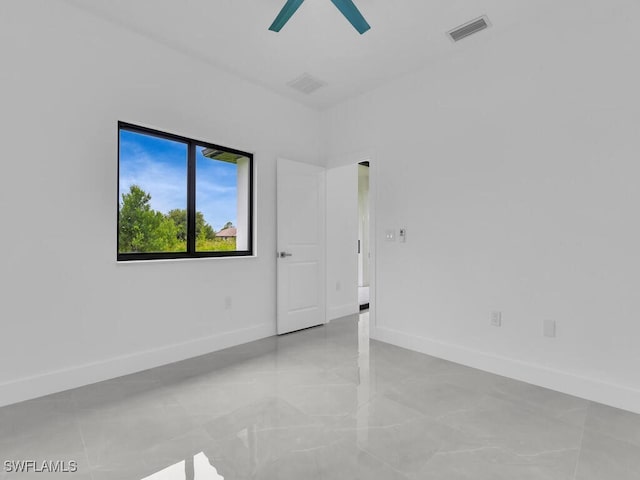 3301 8th St SW, Lehigh Acres, FL 33976 - spare room with a ceiling fan and baseboards