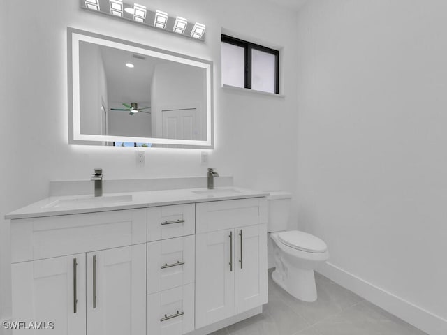 3301 8th St SW, Lehigh Acres, FL 33976 - full bath featuring toilet, double vanity, a ceiling fan, and baseboards
