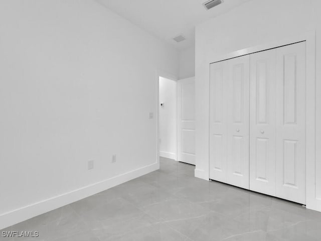 3301 8th St SW, Lehigh Acres, FL 33976 - unfurnished bedroom with a closet and baseboards