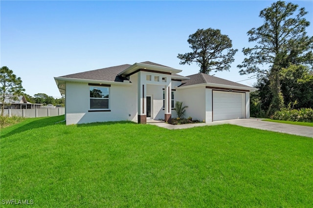 908 Barcia St E, Lehigh Acres, FL 33974 - view of front facade with concrete driveway, stucco siding, a garage, and a shingled roof
