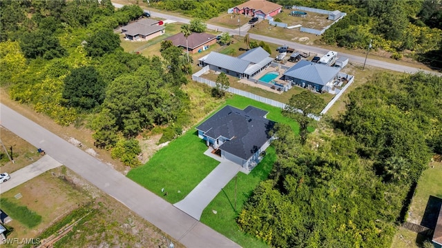 908 Barcia St E, Lehigh Acres, FL 33974 - aerial perspective of suburban area with a pool