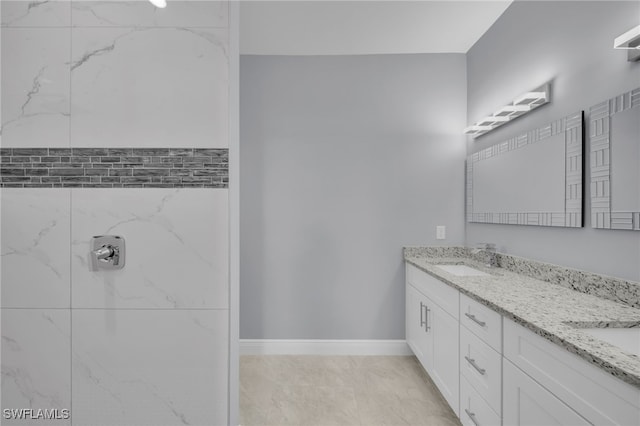 908 Barcia St E, Lehigh Acres, FL 33974 - full bathroom with double vanity and baseboards