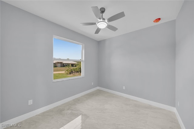 908 Barcia St E, Lehigh Acres, FL 33974 - empty room with ceiling fan and baseboards