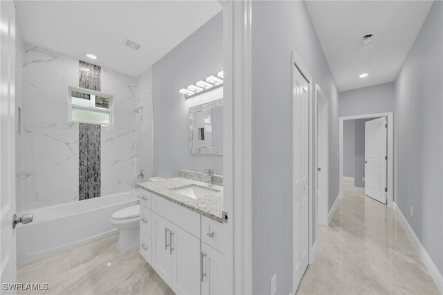 908 Barcia St E, Lehigh Acres, FL 33974 - bathroom featuring vanity,  shower combination, toilet, marble look tile flooring, and recessed lighting