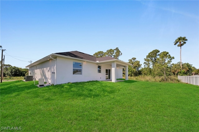 908 Barcia St E, Lehigh Acres, FL 33974 - rear view of property with central AC unit and stucco siding