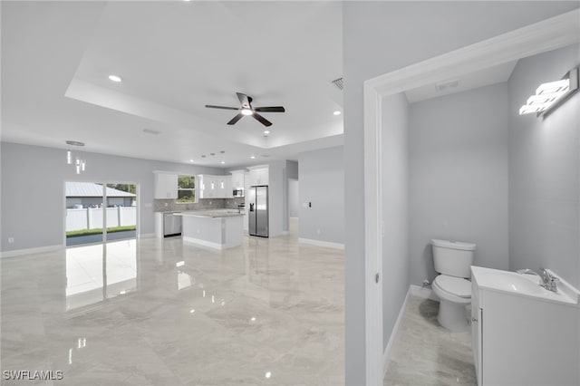 908 Barcia St E, Lehigh Acres, FL 33974 - full bathroom with vanity, toilet, marble tiled flooring, backsplash, and a ceiling fan