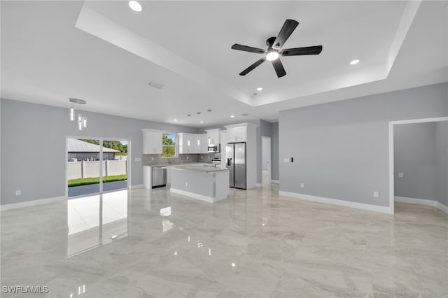 908 Barcia St E, Lehigh Acres, FL 33974 - unfurnished living room featuring recessed lighting, ceiling fan, a raised ceiling, light marble finish floors, and baseboards