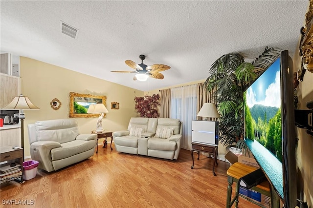 919 Manatee Rd, Naples, FL 34114 - living room with ceiling fan, wood finished floors, and a textured ceiling