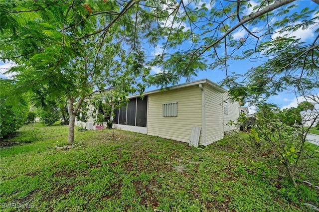 919 Manatee Rd, Naples, FL 34114 - view of property exterior featuring a sunroom and a lawn