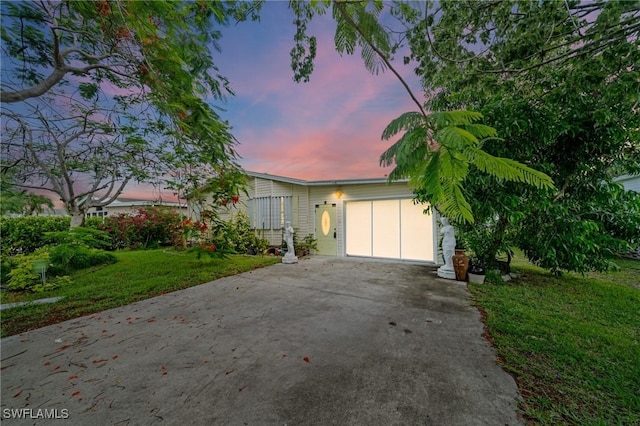 919 Manatee Rd, Naples, FL 34114 - view of front of home with asphalt driveway, a front yard, and a garage